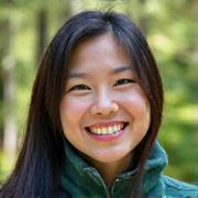 Portrait of a smiling female guide, Lily, wearing outdoor gear.