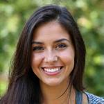 Smiling portrait of Maya Reed, a diverse female guide with a warm demeanor and extensive knowledge of local ecology